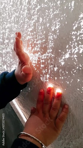 Tiny fingers Soaking up the morning sunshine, big dreams in the morning glow. Pure innocence captured in the soft morning light.