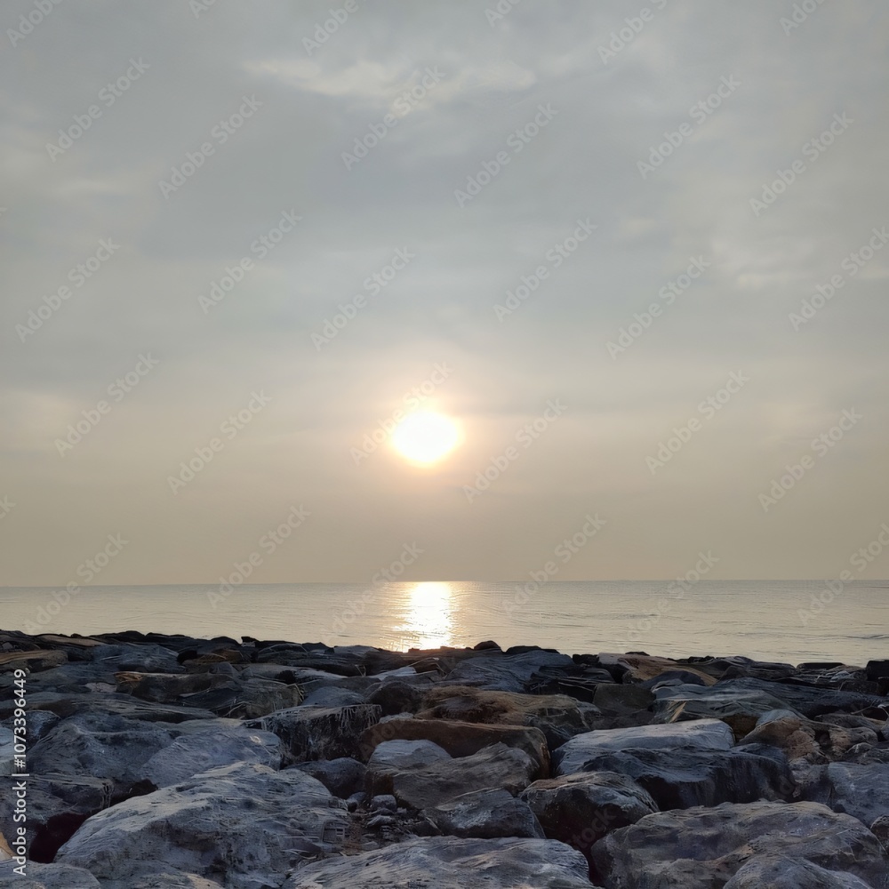 Fototapeta premium Serene Sunrise over Ocean Rocks Calm Coastal Scene