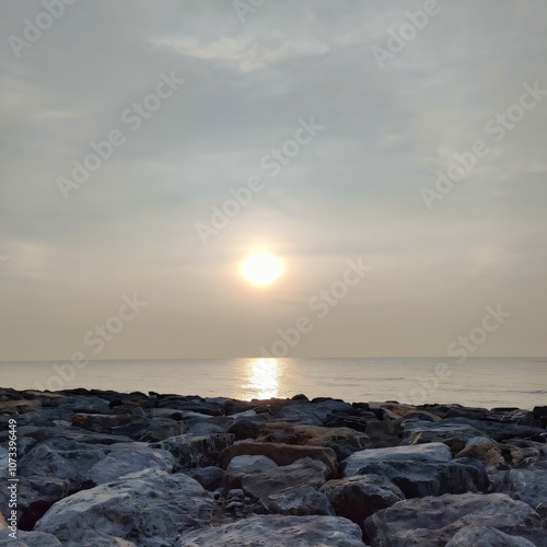 Serene Sunrise over Ocean Rocks Calm Coastal Scene