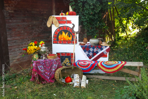 The national Russian reserve Crane Homeland. A Russian-style photo zone with a stove, samovar, cast iron, rugs, baskets, grips and bast shoes photo