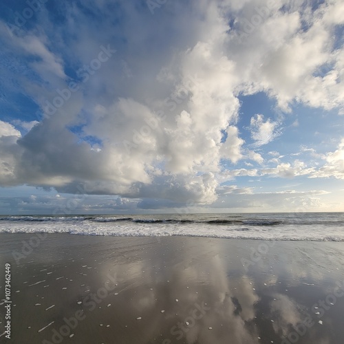 beach and ocean landscape with clouds and reflections 