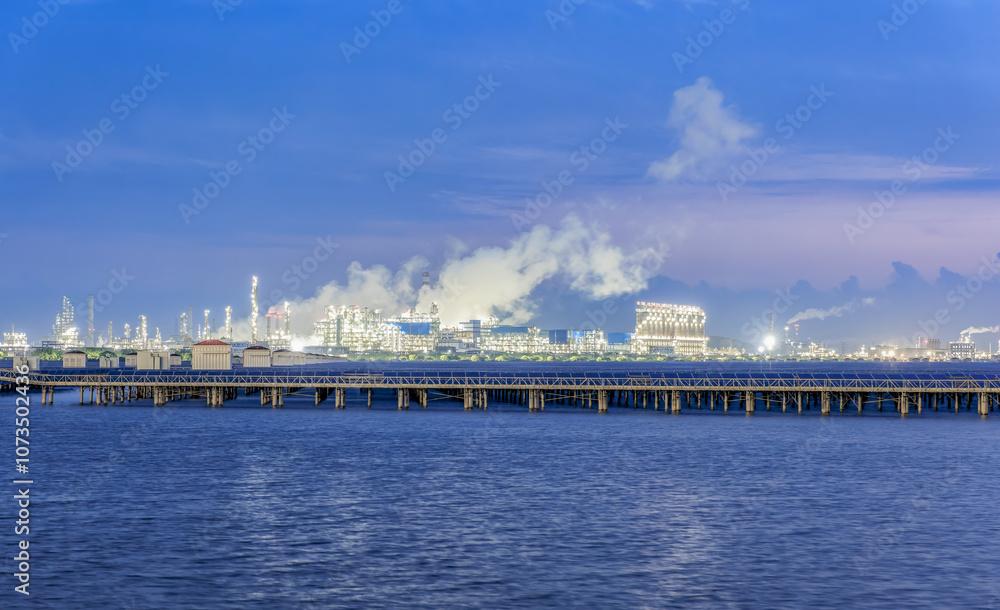 Petrochemical plant industrial equipment and river at sunset. Business Finance and Industry Petrochemical plant industrial equipment and river at sunset. Business Finance and Industry
