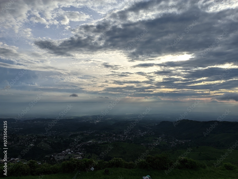 Breathtaking panoramic view of a valley bathed in the soft glow of sunset. 