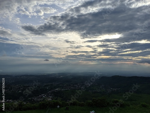 Breathtaking panoramic view of a valley bathed in the soft glow of sunset. 