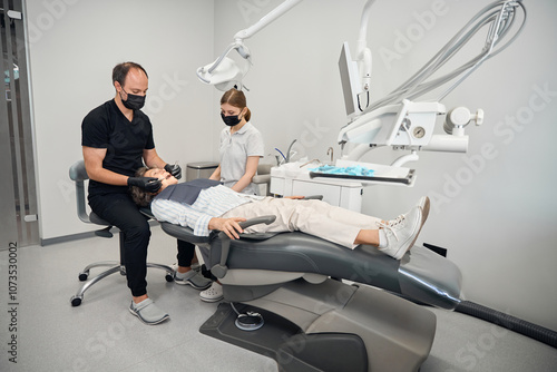 Elderly lady lies in a modern dental chair