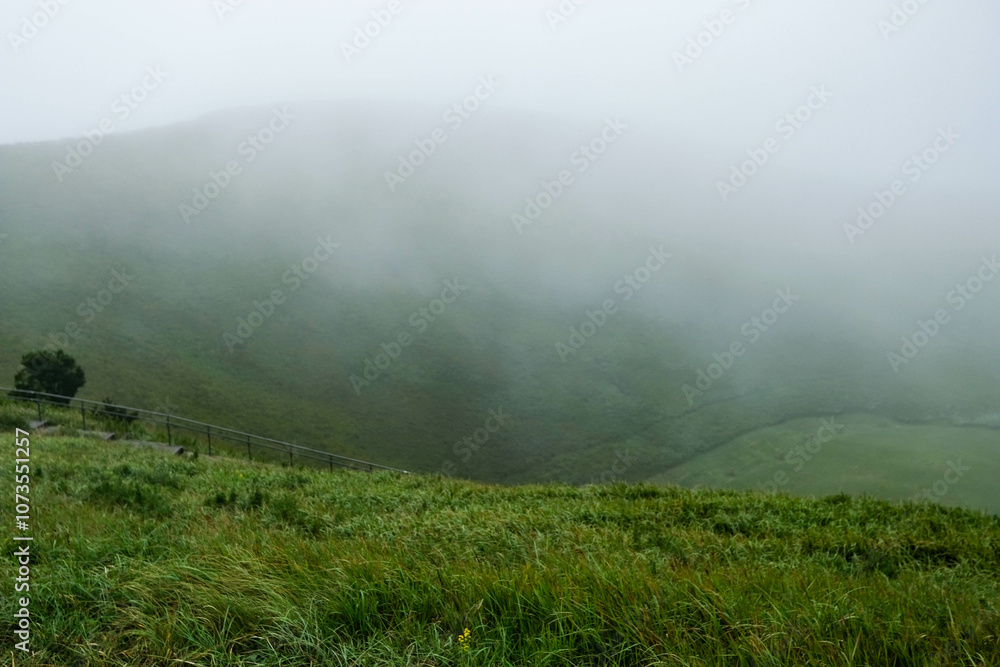 Mount Omuro, Izu tobu, Ito, Shizuika in Japan of mountain view in a foggy day with the green trees grass field with small houses and small trees Mount Omuro, Izu tobu, Ito, Shizuika in Japan of mountain view in a foggy day with the green trees grass field with small houses and small trees