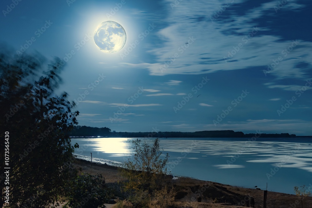 Brightly lit full moon on the beach of the Baltic Sea