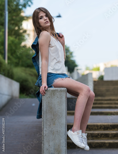 20 yo white woman sitting against a wall in Brussels, Belgium.