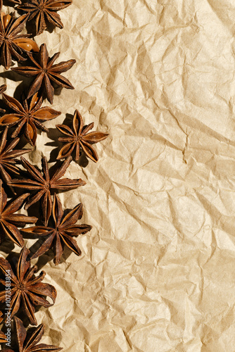 Anise stars pattern, above view close up flavor spices dried anise seeds on paper, still life with natural condiments, aromatic ingredient for cooking, rustic style food background, gastronomy theme photo