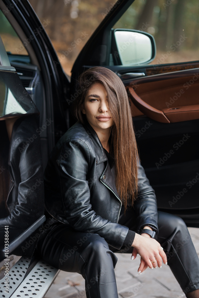 Stylish Young Woman in Leather Outfit Posing by Car Stylish Young Woman in Leather Outfit Posing by Car