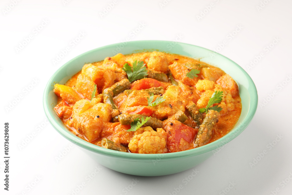 Mix vegetable curry - Indian main course recipe contains Carrots, cauliflower, green peas and beans and served in ceramic bowl Mix vegetable curry - Indian main course recipe contains Carrots, cauliflower, green peas and beans and served in ceramic bowl