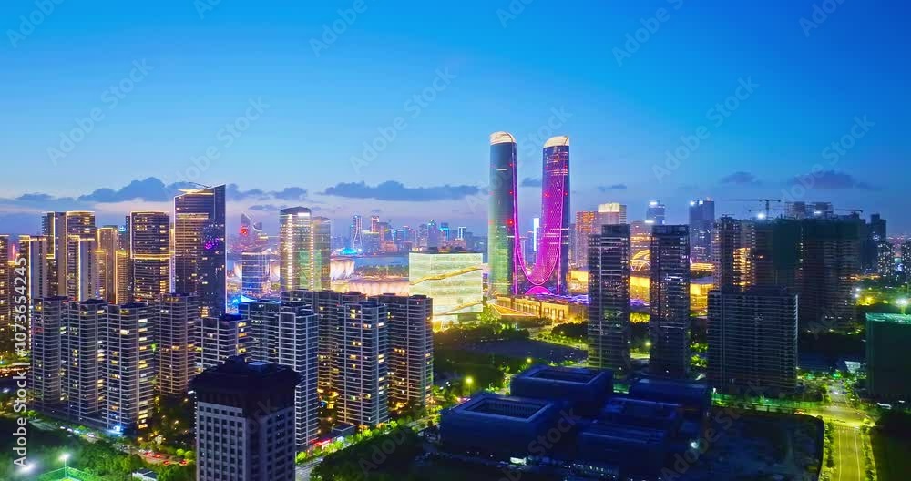 Commercial buildings and skyline in modern city at night in Hangzhou, China Commercial buildings and skyline in modern city at night in Hangzhou, China