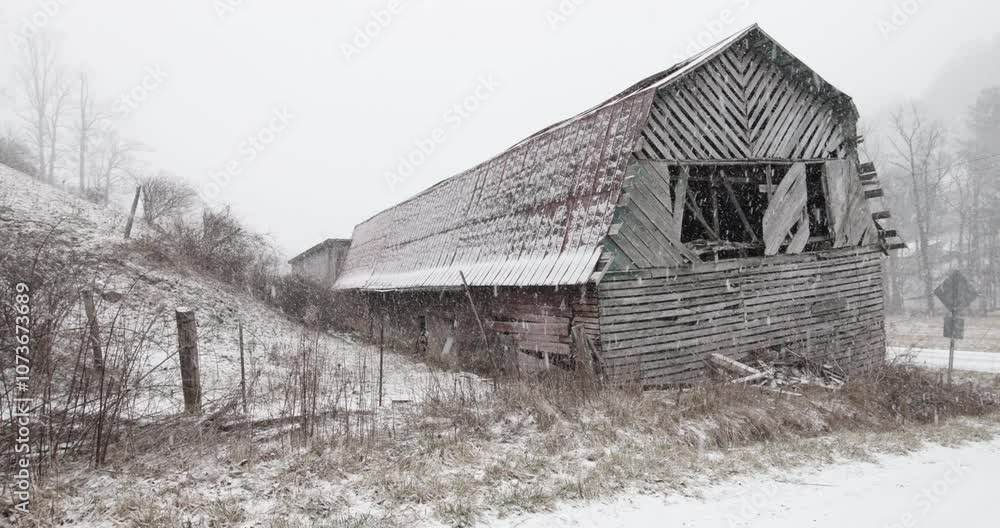 Wide shot of a dilapidated barn near Boone, North Carolina during a snowstorm. No sound. Wide shot of a dilapidated barn near Boone, North Carolina during a snowstorm. No sound.