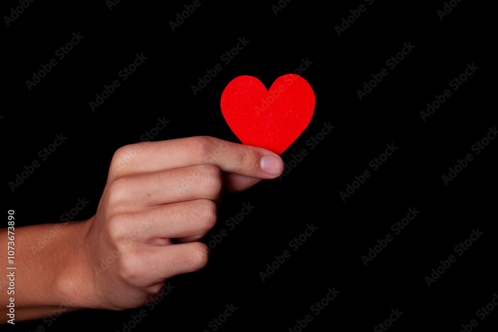 boy holding a red heart in his hand boy holding a red heart in his hand