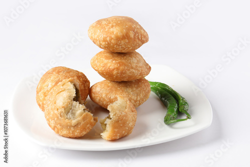 Kachori, green chilly, kachori is a spicy snack from India also called  kachauri and kachodi. Favorite Tea time snacks
served in a ceramic plate photo