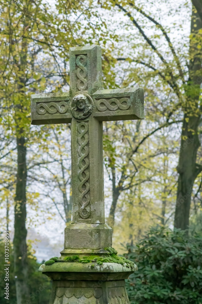 Stone cross standing in cemetery representing faith and remembrance Stone cross standing in cemetery representing faith and remembrance