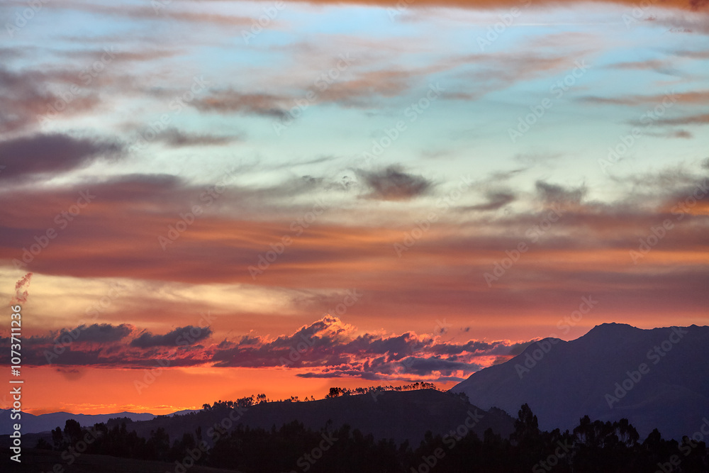 Fototapeta premium The sun dips below the hills of Chinchero, casting a golden embrace over this sacred land.Nature and history blend seamlessly as the day ends, reminding us of the timeless beauty of Peru’s Andes.
