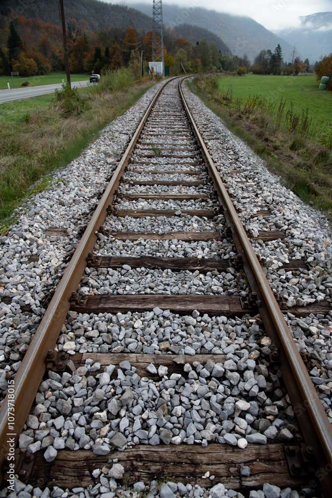 Railroad tracks disappearing into the mountainous landscape. Train lines outdoors. Public transportation Railroad tracks disappearing into the mountainous landscape. Train lines outdoors. Public transportation