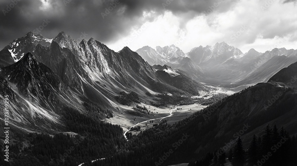Obraz premium A dramatic black and white landscape photograph of a valley nestled between towering mountains, with a sliver of light shining through the dark clouds.