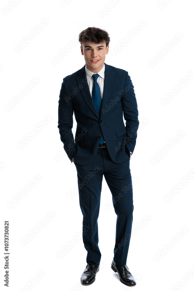 happy elegant businessman in navy blue suit holding hands in pockets happy elegant businessman in navy blue suit holding hands in pockets