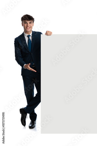 proud young businessman presenting white board and smiling