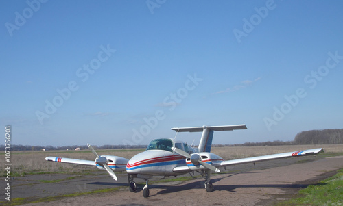 A twin-engine propeller plane is on the ground