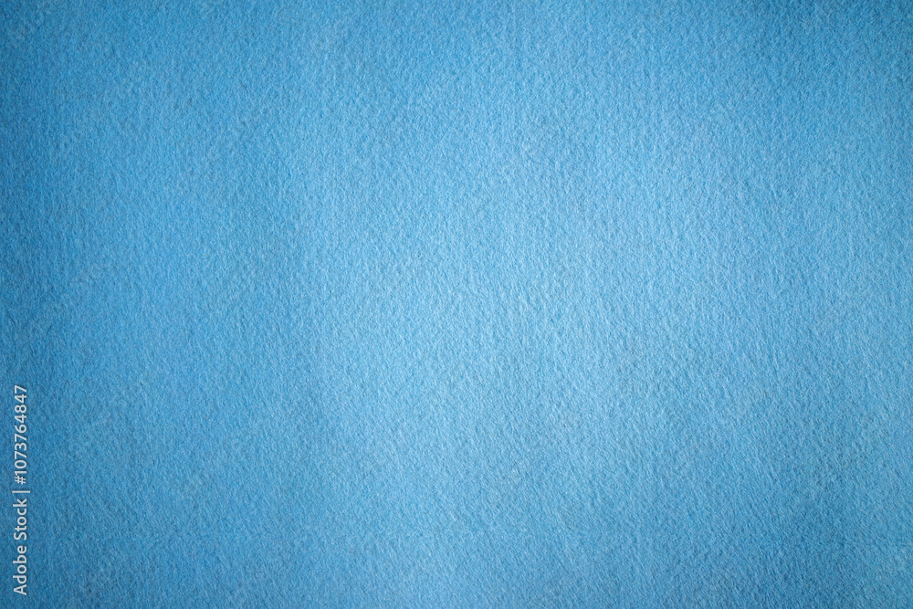 Fototapeta premium A photo of the texture of a blue felt fabric.Textile material for embroidery and needlework.Soft blue background.