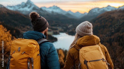 A couple wearing backpacks is hiking towards a scenic mountain view, warmly dressed and cozy against the crisp air, with an expansive vista of nature around them.