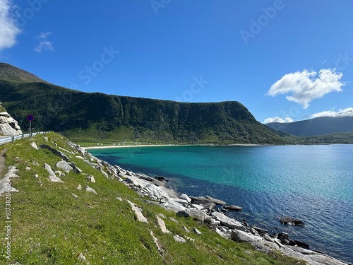 Breathtaking landscape of Norway's Lofoten Islands, with towering mountains and the serene Arctic Ocean. A stunning display of natural beauty and rugged coastal charm. photo