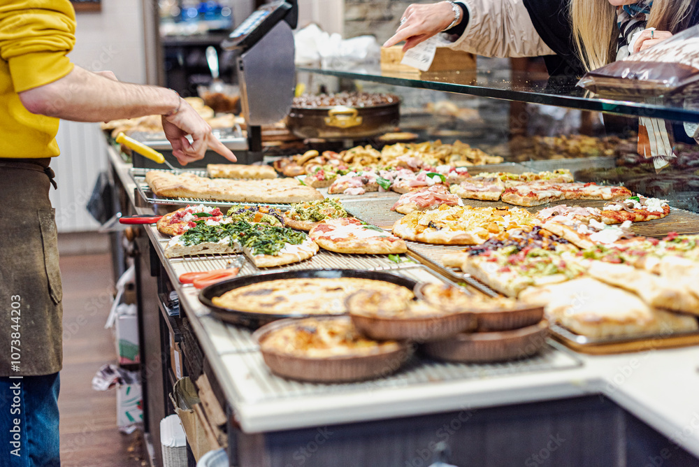 Obraz premium Pizza by the slice in an italian bakery.