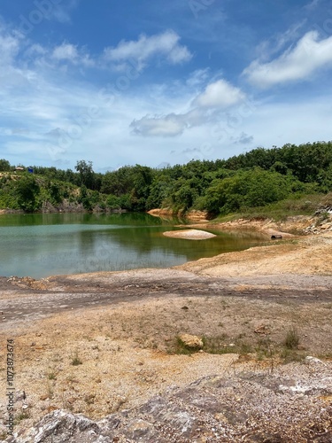 landscape with water, a blue sky,  in a hidden valley in the country side of South East Asia