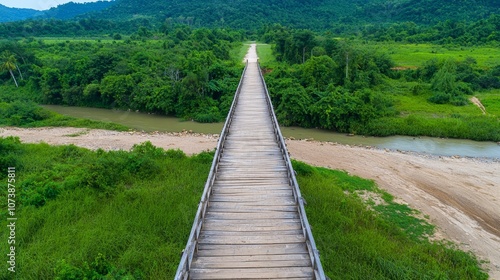 Wallpaper Mural Scenic Wooden Bridge Over Waterway Surrounded by Lush Green Landscape and Mountains in the Background, Ideal for Nature and Adventure Themes Torontodigital.ca