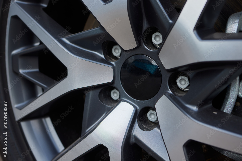 Detailed shot of a sleek black and silver alloy wheel on a motor vehicle Detailed shot of a sleek black and silver alloy wheel on a motor vehicle