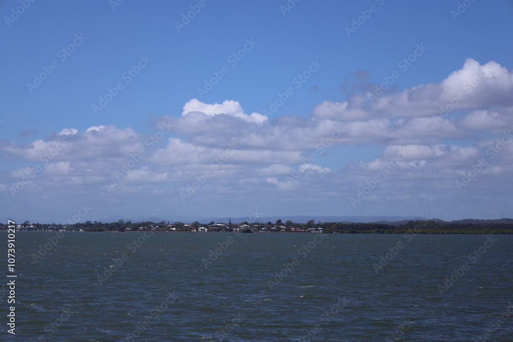 distant seashore village viewed from at sea distant seashore village viewed from at sea