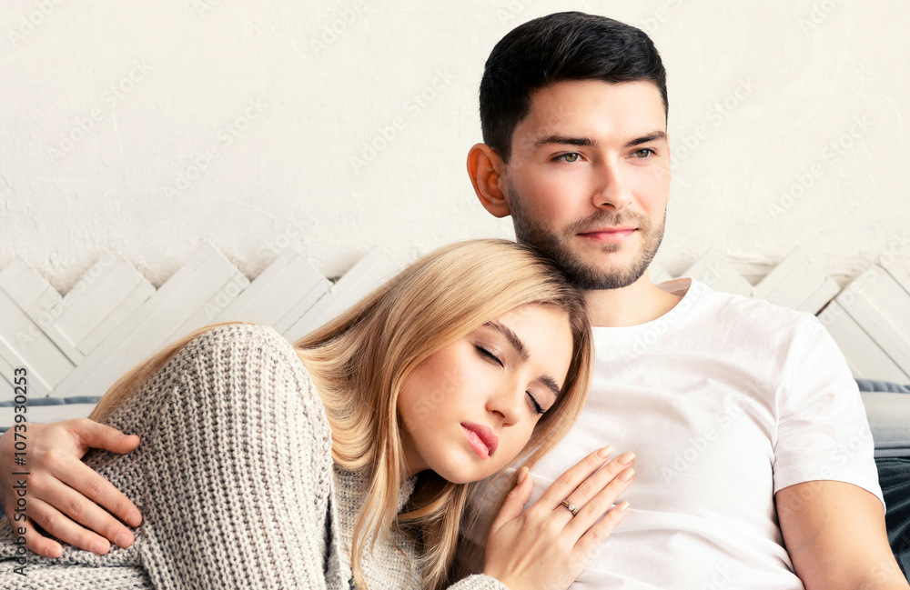Handsome young guy watching TV while his girlfriend sleeping at home, panorama Handsome young guy watching TV while his girlfriend sleeping at home, panorama