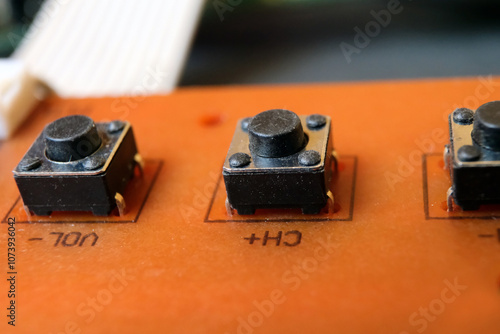 Tactile switches on an electronic circuit board. Tact buttons in a row. photo