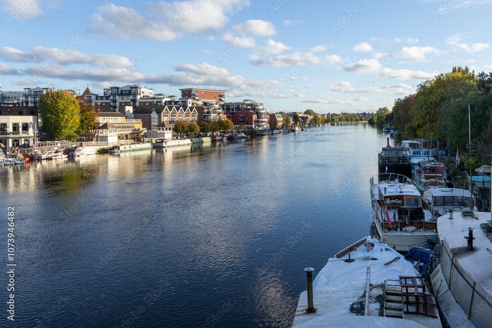 Fototapeta premium Kingston Upon Thames quayside with people enjoying the late afternoon sun
