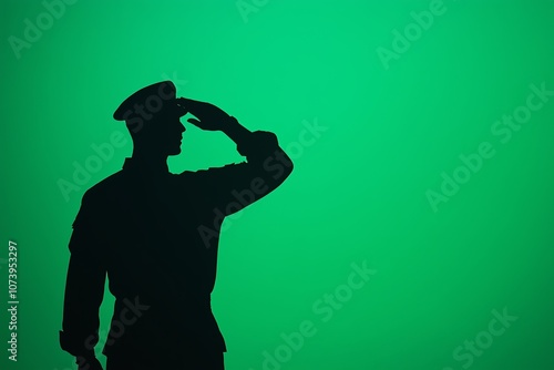 Silhouette of a soldier saluting against a gradient green background representing respect, military service, and patriotism. photo