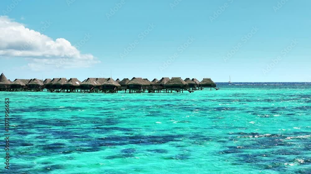 Drone Tahiti. Aerial view of Moorea island lagoon, overwater bungalows in clear ocean water. Luxury honeymoon vacation, romantic getaway. French Polynesia. Drone Tahiti. Aerial view of Moorea island lagoon, overwater bungalows in clear ocean water. Luxury honeymoon vacation, romantic getaway. French Polynesia.