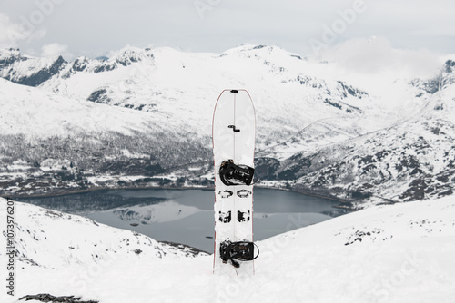 Fototapeta Naklejka Na Ścianę i Meble -  Close-up of a white splitboard standing in the snow against the background of a beautiful mountain