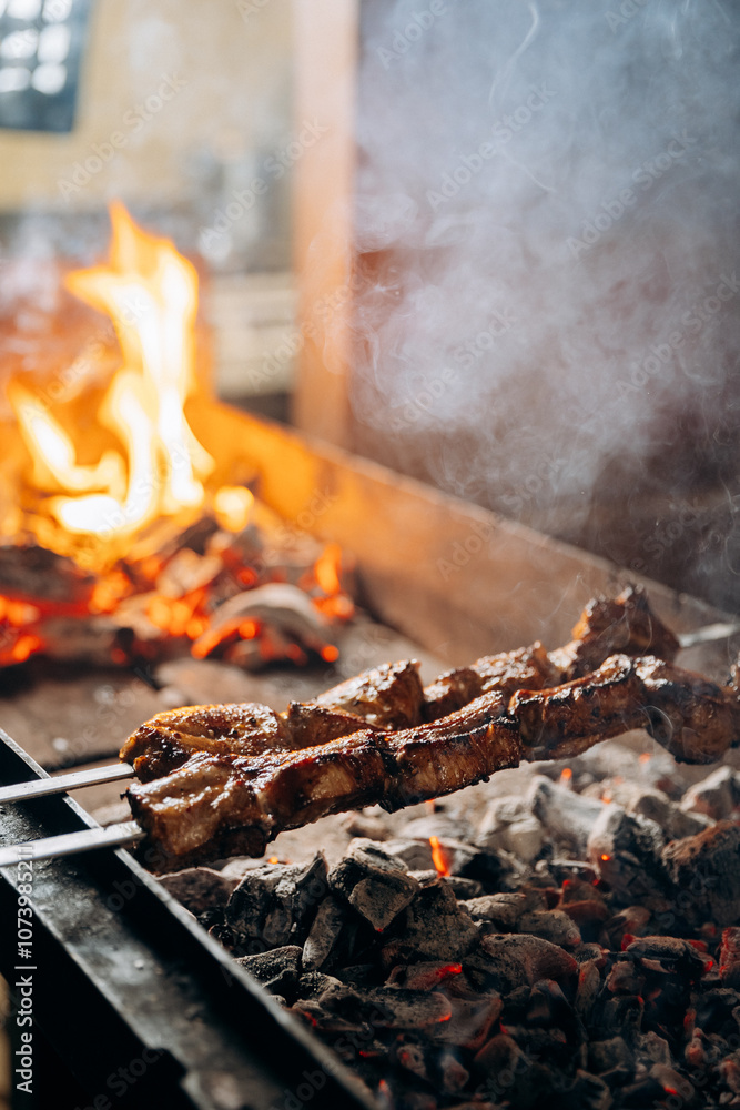 Grilled meat skewers roasting over charcoal flames, capturing the essence of BBQ perfection Grilled meat skewers roasting over charcoal flames, capturing the essence of BBQ perfection
