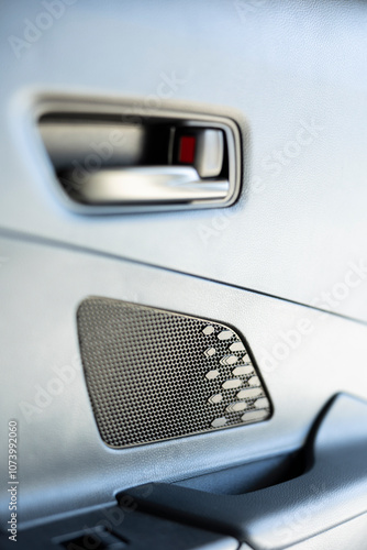 Close up shot of mechanism used for closing and opening car door by using lock controls on panel to lock it or unlock it. Automobile door handle controlled by buttons disengaging mechanism latch photo