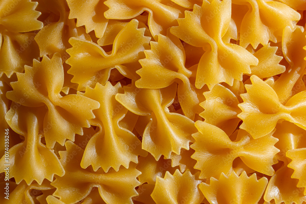 Uncooked Farfalle Pasta: A Culinary Canvas of Bow-Tie Macaroni, Creating a Lively and Textured Background for Gourmet Cooking. Dry Pasta. Raw Macaroni - Top View, Flat Lay Uncooked Farfalle Pasta: A Culinary Canvas of Bow-Tie Macaroni, Creating a Lively and Textured Background for Gourmet Cooking. Dry Pasta. Raw Macaroni - Top View, Flat Lay