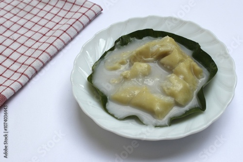 Semar Mendem Solo is a traditional Surakarta snack, made from glutinous rice and filled with shredded chicken or beef in a thick coconut milk sauce. The outer layer is coated with flour and egg batter photo