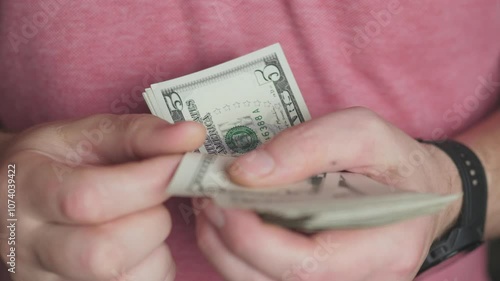 A closeup showing hands counting dollar bills, highlighting the importance of cash management in transactions