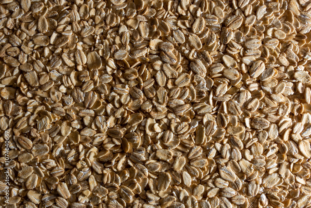 Uncooked Oat Flakes background - Top View, Flat Lay. Scattered Dry and Raw Oat Flakes. Healthy Breakfast and Diet Eating Ingredients Uncooked Oat Flakes background - Top View, Flat Lay. Scattered Dry and Raw Oat Flakes. Healthy Breakfast and Diet Eating Ingredients