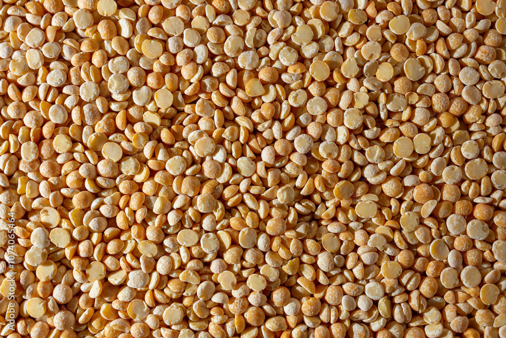 Uncooked Polished Split Peas Background. A Culinary Canvas of Dry Yellow Peas, Creating a Lively and Textured Background for Gourmet Cooking. Scattered Raw Polished Peas. Healthy Eating Ingredients Uncooked Polished Split Peas Background. A Culinary Canvas of Dry Yellow Peas, Creating a Lively and Textured Background for Gourmet Cooking. Scattered Raw Polished Peas. Healthy Eating Ingredients