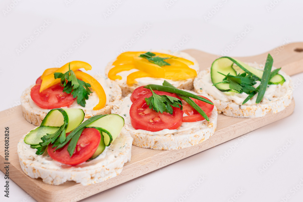 Different Vegan Rice Cake Sandwiches with Fresh Tomato, Yellow Paprika and Greens on Wooden Cutting Board. Vegetarian Diet Food. Quick and Healthy Sandwiches. Crispbread with Fresh Fillings Different Vegan Rice Cake Sandwiches with Fresh Tomato, Yellow Paprika and Greens on Wooden Cutting Board. Vegetarian Diet Food. Quick and Healthy Sandwiches. Crispbread with Fresh Fillings