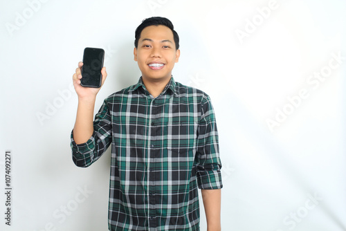 attractive asian man smiling happy while showing smartphone screen isolated on white background