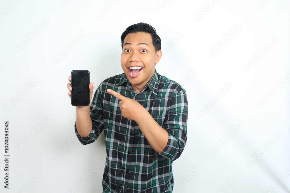 cheerful and excited asian man pointing smartphone screen with surprised face isolated on white background cheerful and excited asian man pointing smartphone screen with surprised face isolated on white background